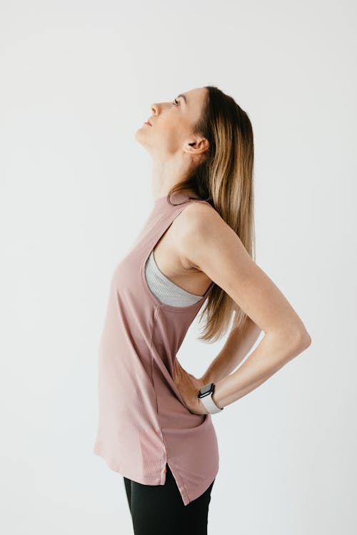 Confident young sportswoman strengthening back muscles during training