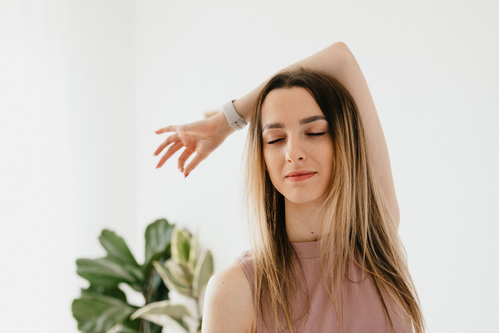 Woman with closed eyes and calm expression practicing seated breathing meditation with hand mudra