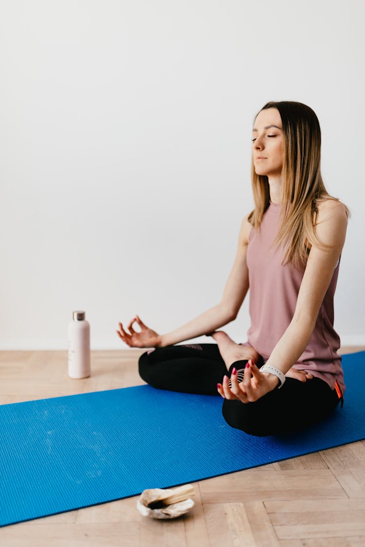 Relaxed Woman Sitting In Lotus Pose