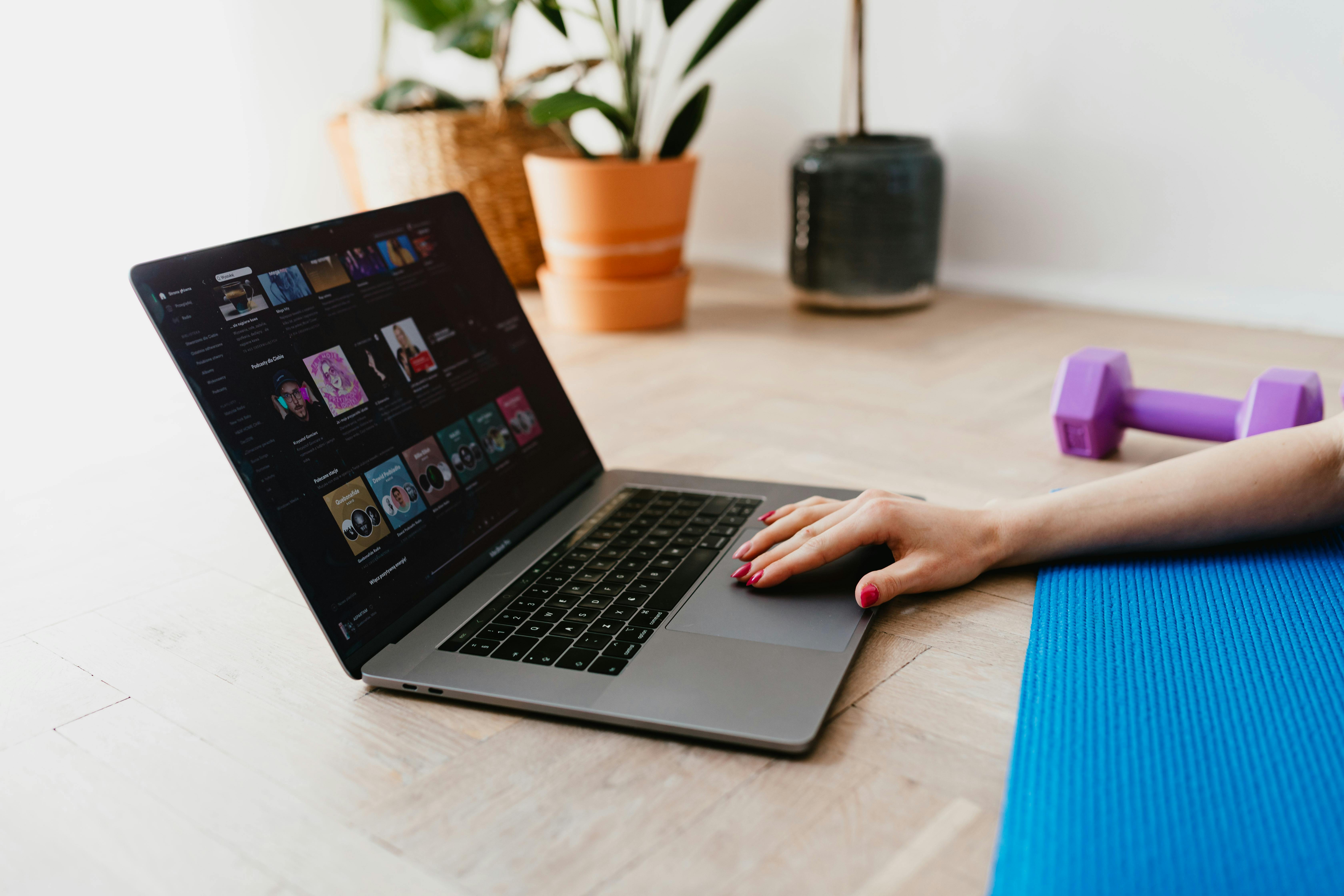 faceless woman using laptop during sport exercising