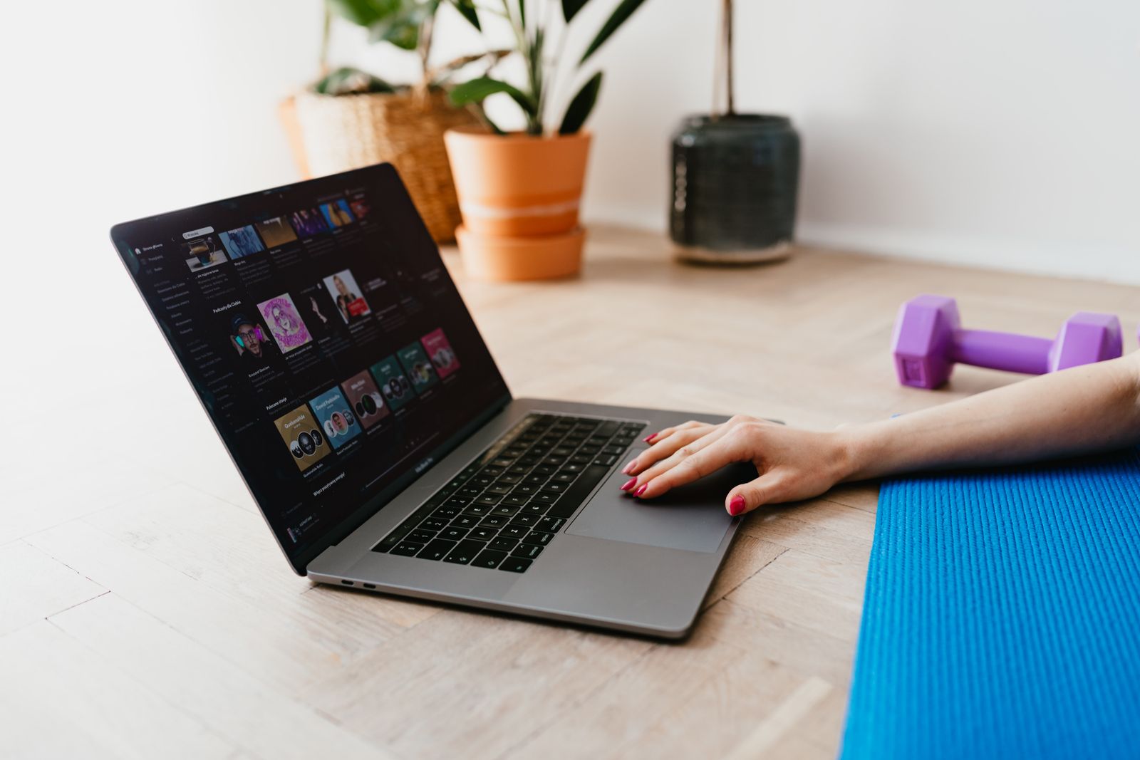 Woman following an online workout video on her laptop from home