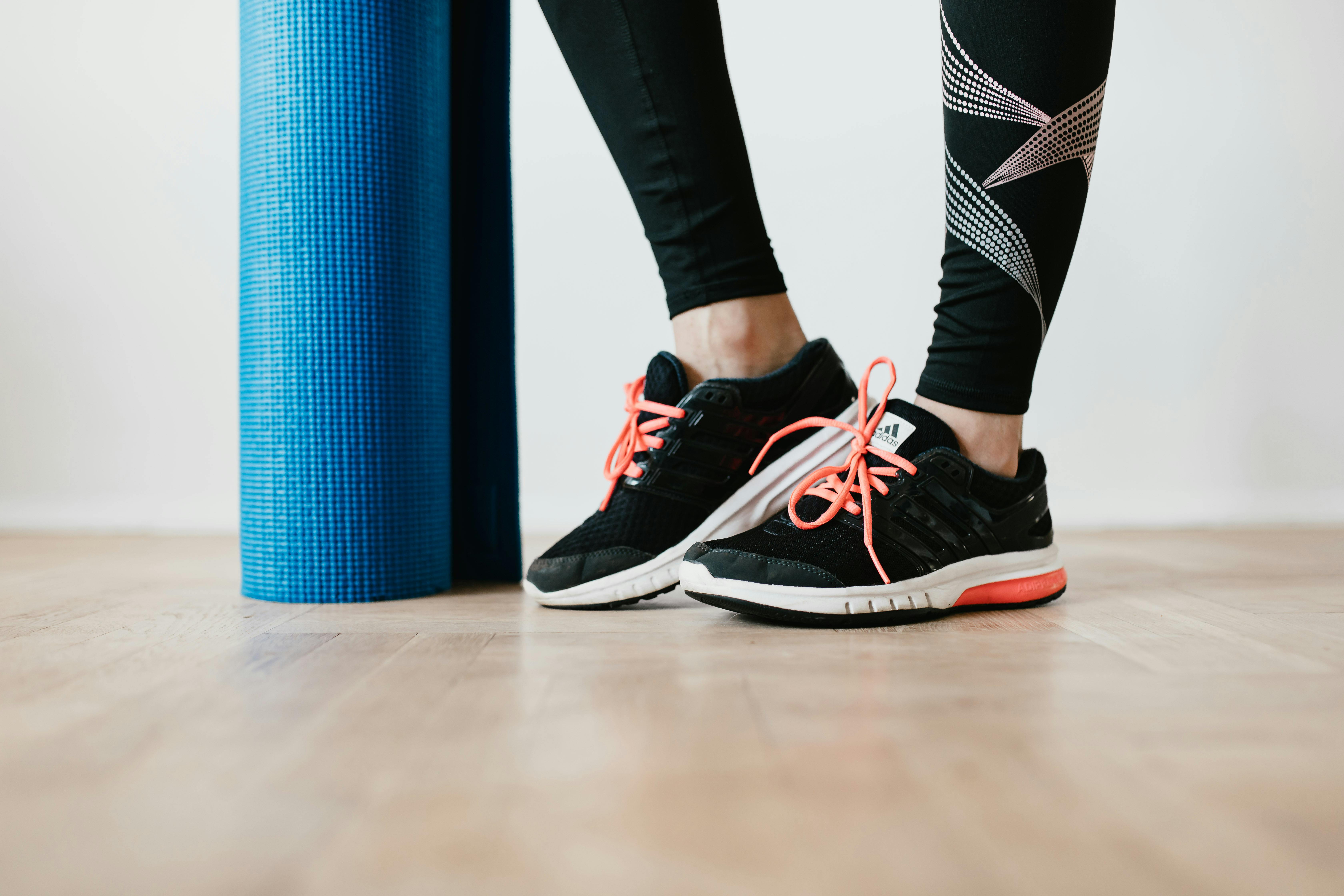 crop female athlete with sport mat