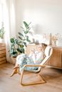 Woman in White Shirt Sitting on Brown Wooden Armchair