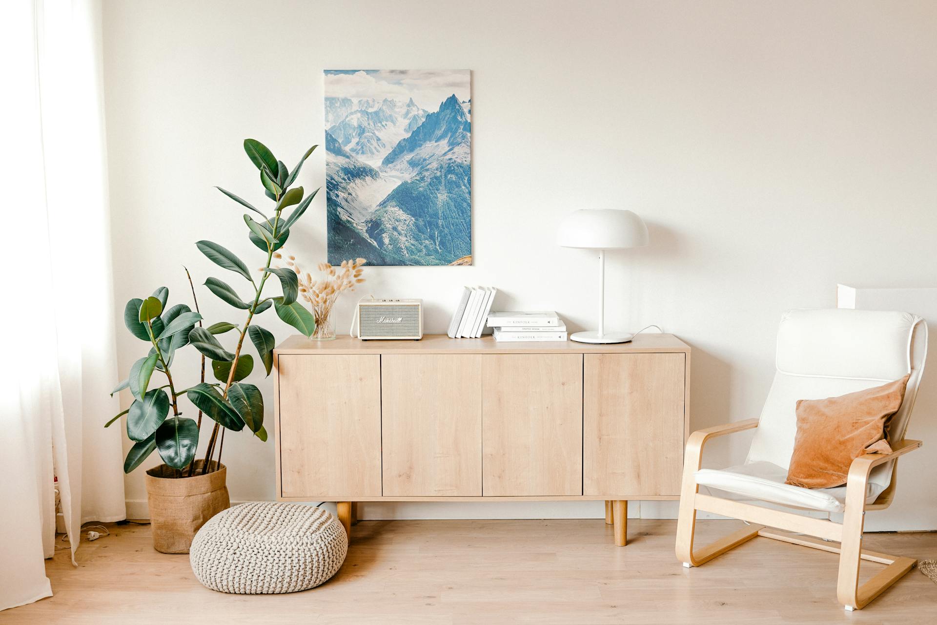 A calming minimalist living room with a wooden cabinet and stylish decor elements.