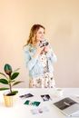 Woman in White and Green Floral Dress Holding White Ceramic Mug