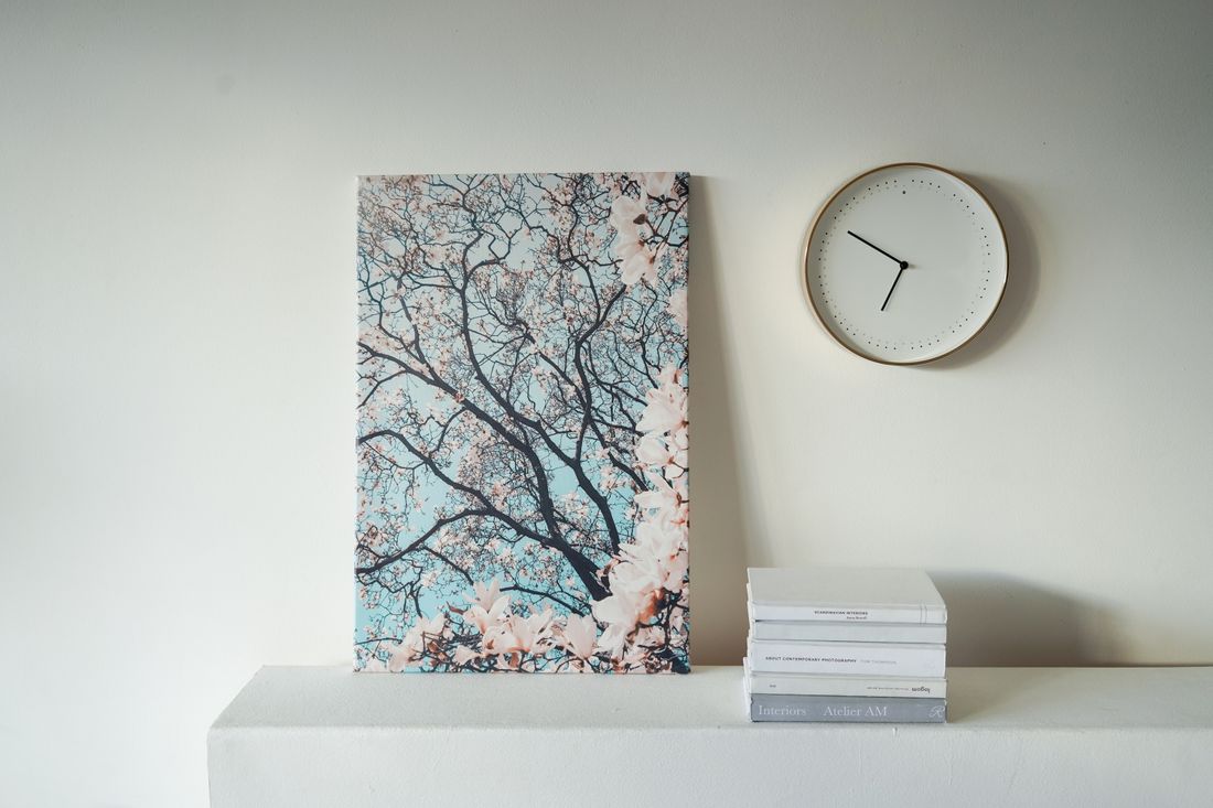 Photo books and printed artwork arranged on a table