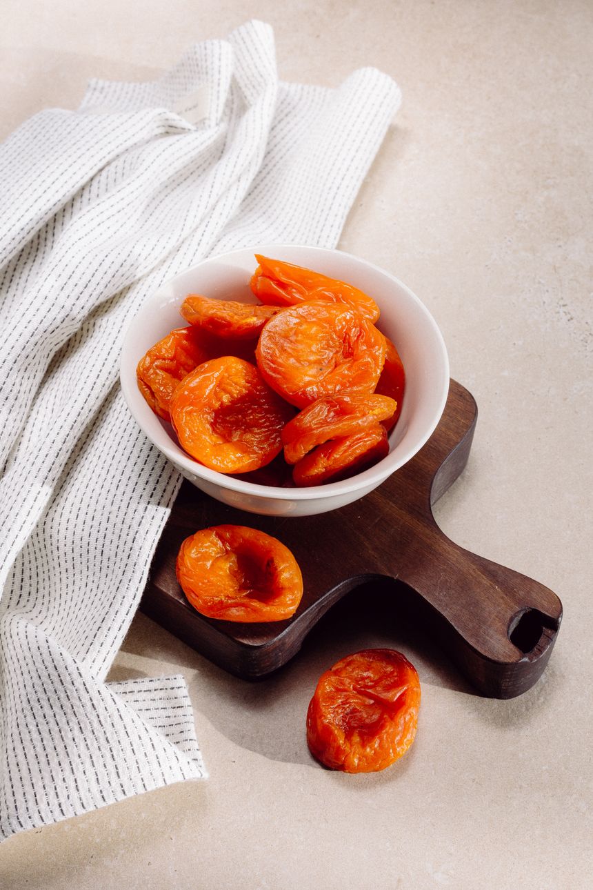 Glazed fruit in a ceramic bowl on a wooden tray — photo by AI25.Studio on Pexels