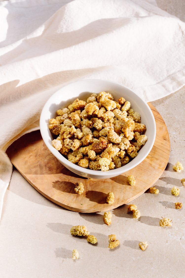 Dried Mulberries On White Ceramic Bowl