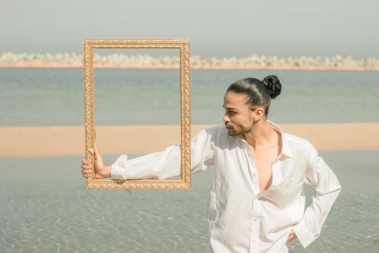 Portrait Of A Man Holding A Frame