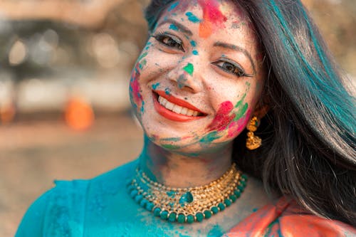 Free A Beautiful Woman Smiling with Painting on Her Face Stock Photo