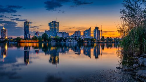 Free Stunning sunset view of Vienna's skyline reflecting in the Danube River, showcasing urban architecture and nature. Stock Photo