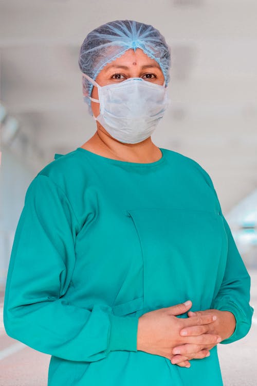 Free Woman Wearing a Hair Net and Face Mask Stock Photo