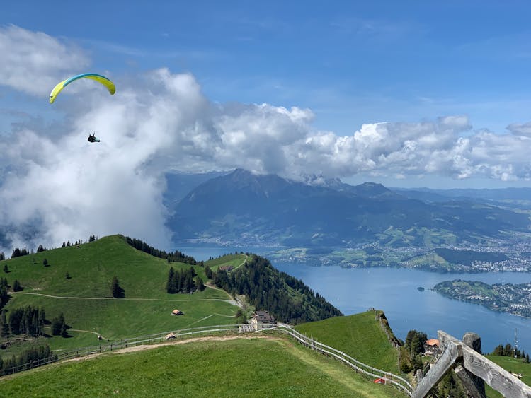 Person Paragliding Over Mountain