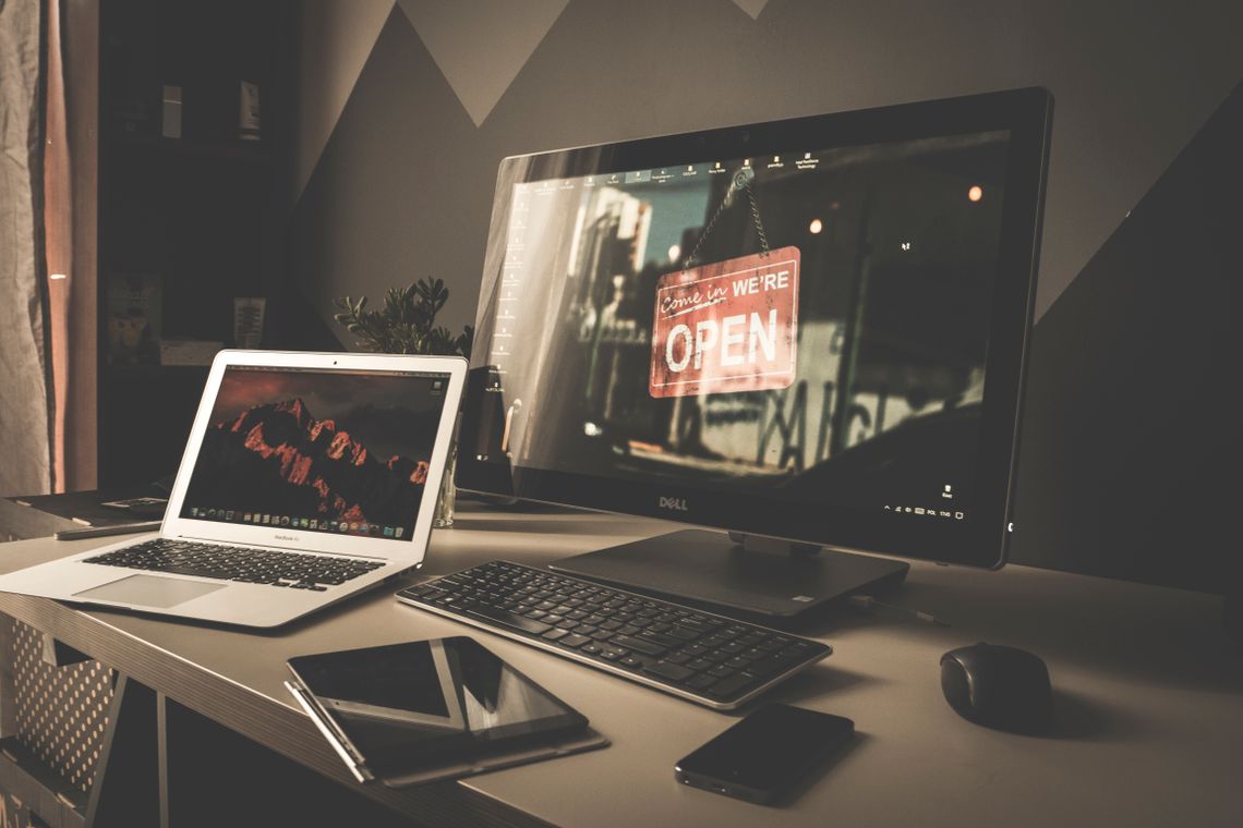 Clean computer workstation with desk, display, chair and office accessories