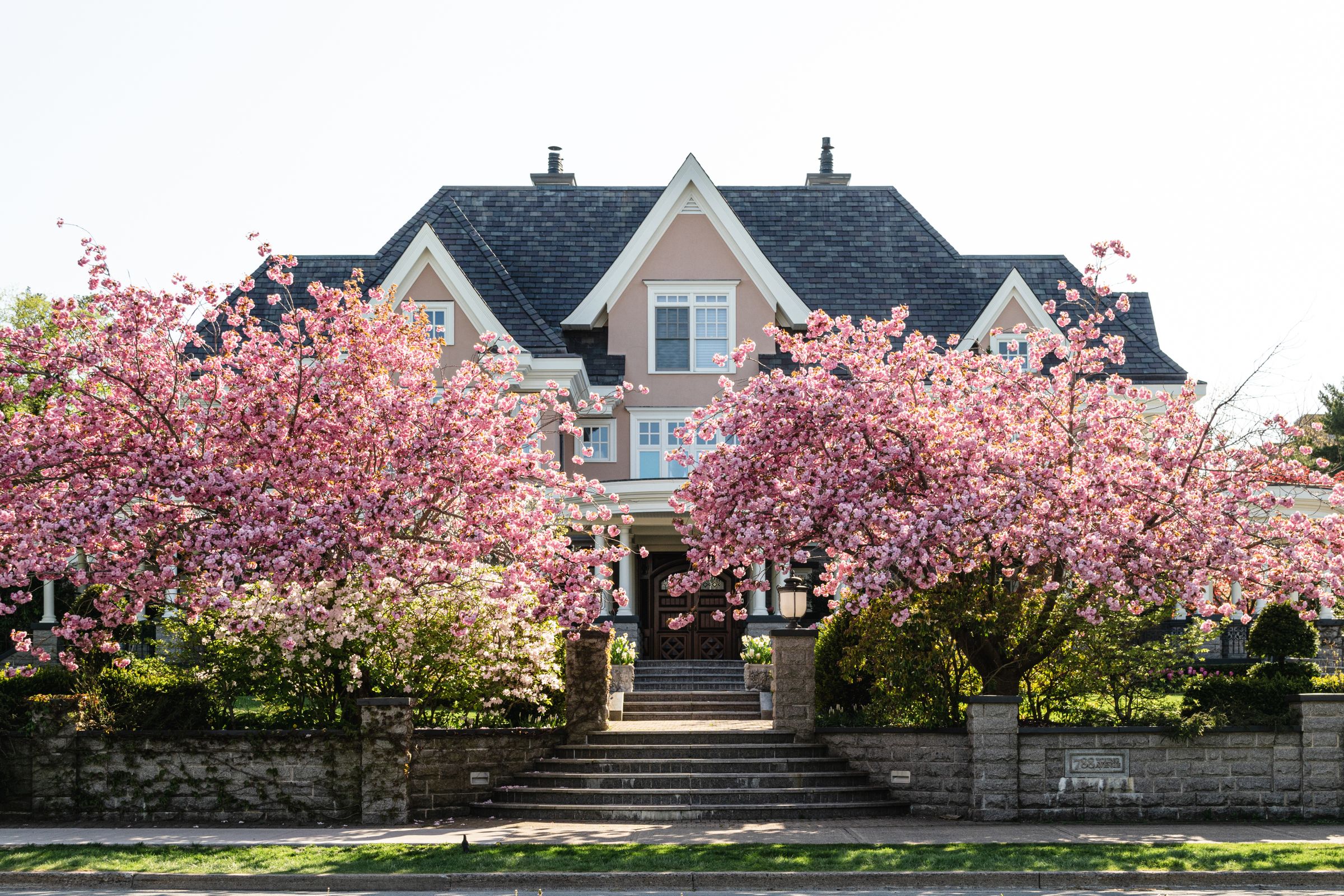 Exterior of home with blooming cherry trees in spring
