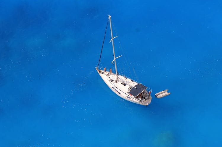 White Boat And An Inflatable Boat At Sea