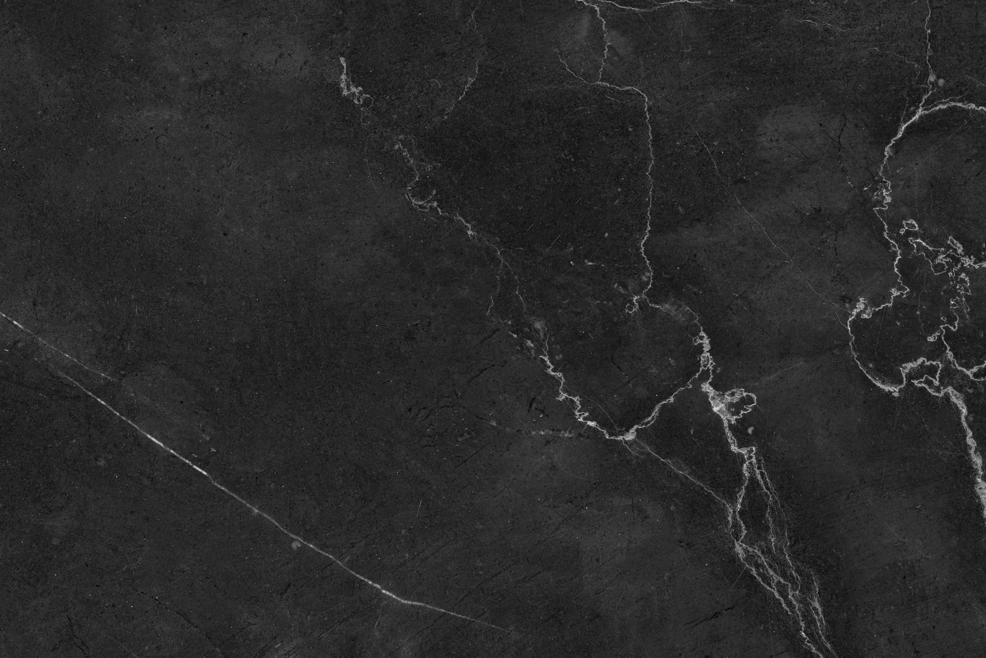 Black marble texture with striking white veins