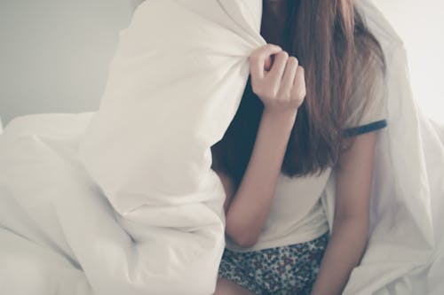 Free Woman Under Comforter Stock Photo