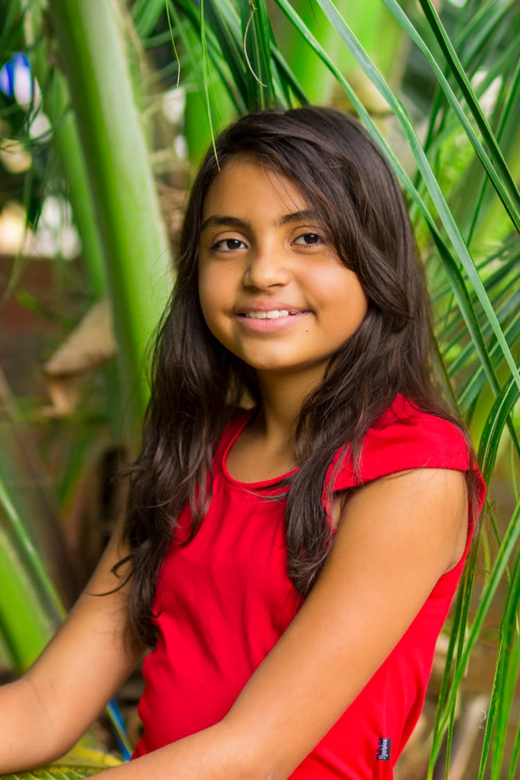 Positive Ethnic Girl In Garden