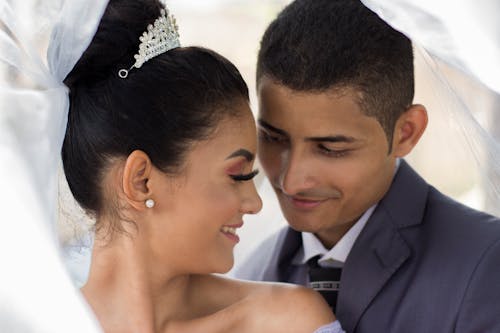 Free Happy newlywed ethnic couple in wedding suits Stock Photo