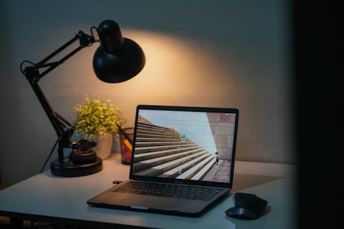 Free Black Desk Lamp and a Laptop on a White Table Stock Photo