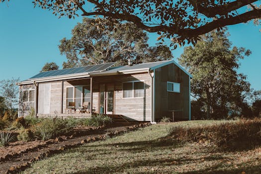 Wooden House With Solar Panels Near Green Trees