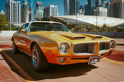 Photo of Yellow Pontiac Car Parked on Parking Lot