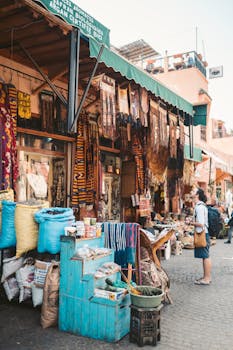 Vibrant scene at a Marrakesh street market showcasing diverse merchandise and lively atmosphere.