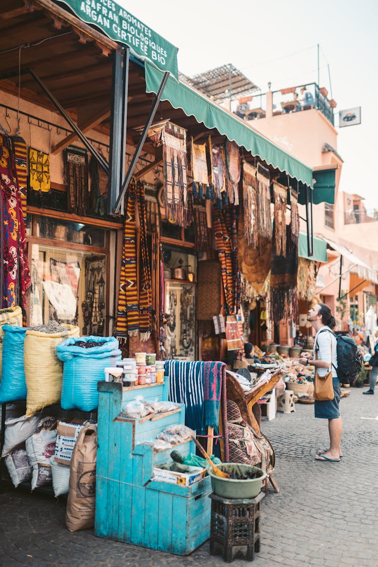 Man In White Shirt In A Flea Market