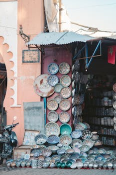 Vibrant handcrafted ceramic plates displayed at a Marrakesh market stall.