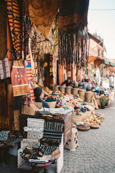 Colorful street market in Marrakesh, Morocco showcasing textiles and handmade crafts.