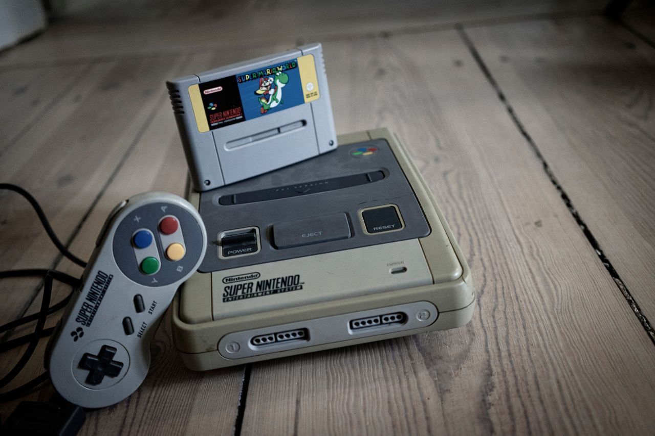 from above of aged video game console with cassette and controller wit