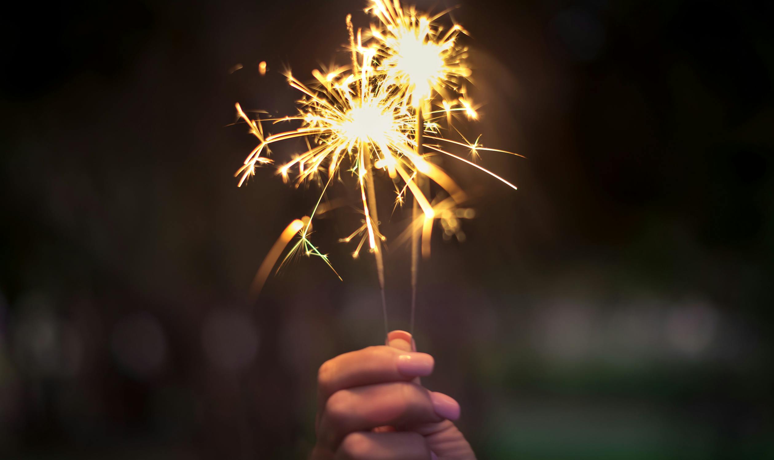 Sparkles Photo by Tairon Fernandez from Pexels: https://www.pexels.com/photo/person-holding-lighted-sparkler-450301/