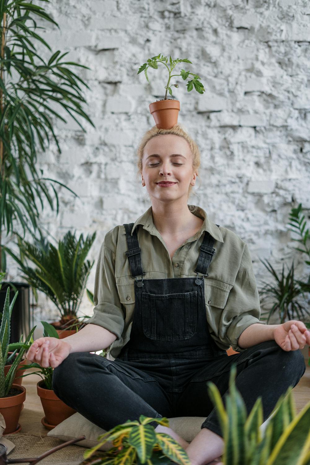 pregnancy and oral health: woman sat meditating with plant 
