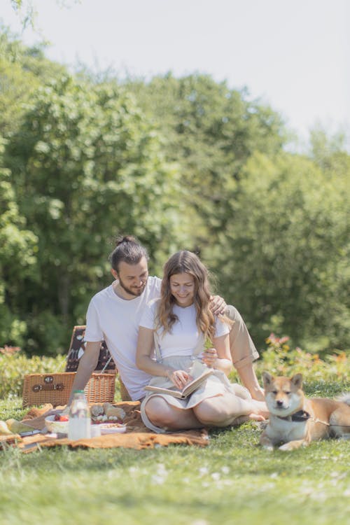 Couple Having a Picnic with their Dog 