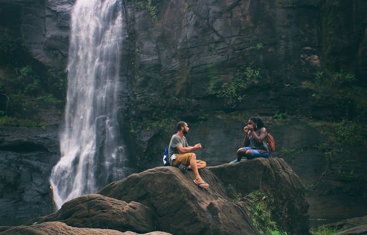 Free Man and Woman Near Waterfall Stock Photo