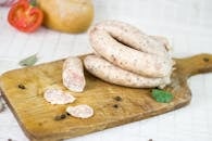 White Sausage on Brown Wooden Chopping Board