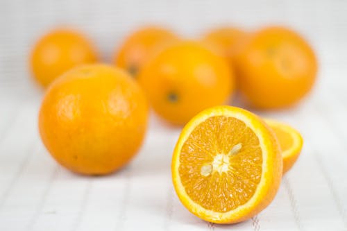 Free Sliced Orange Fruit on a White Surface Stock Photo