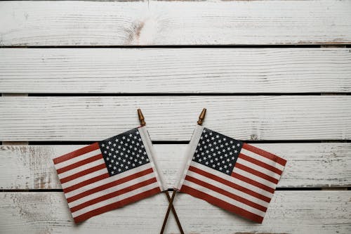 USA flags on sticks on wooden table