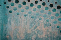 Textured backdrop of rusty metal sheet with holes