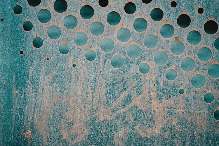 Textured Backdrop Of Rusty Metal Sheet With Holes