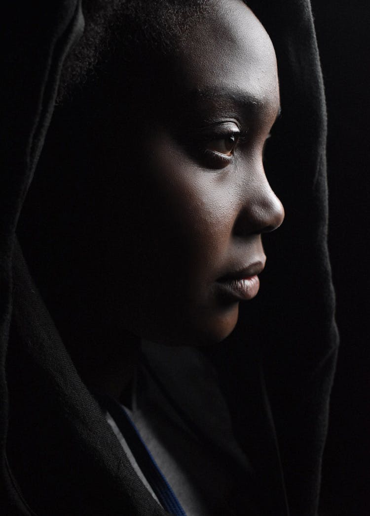 Crop Pondering Black Woman In Dark Room