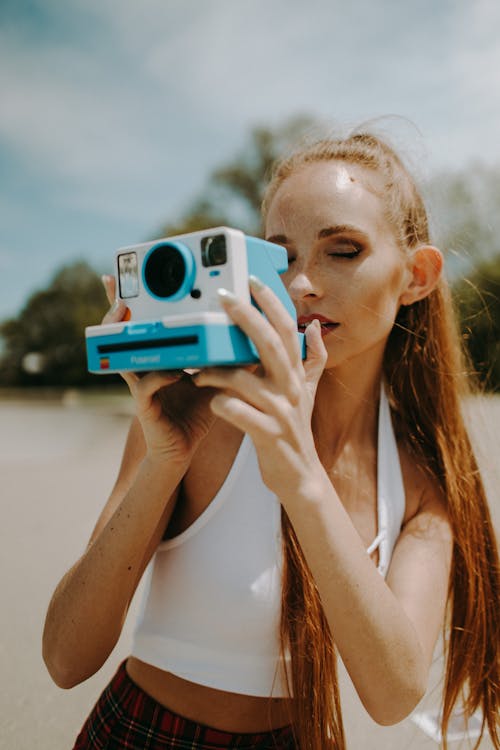 Woman Taking Pictures in a Vintage Camera