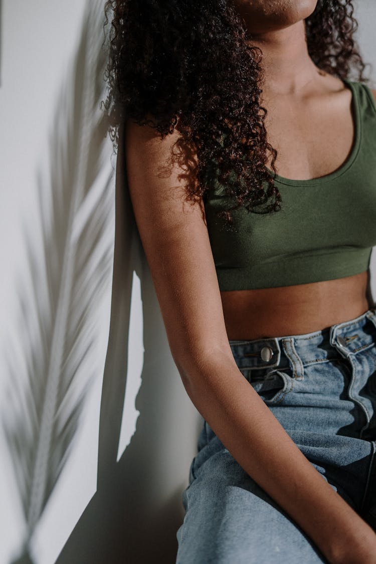 Woman In Green Tank Top And Blue Denim Jeans