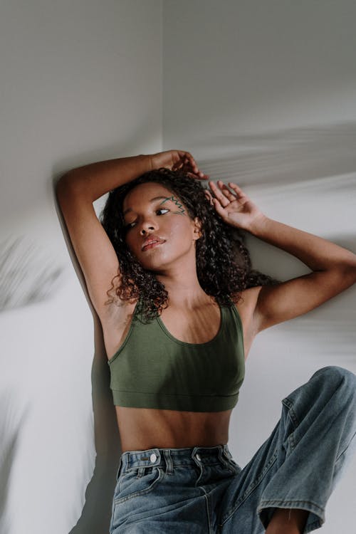 Woman in Green Tank Top and Gray Pants