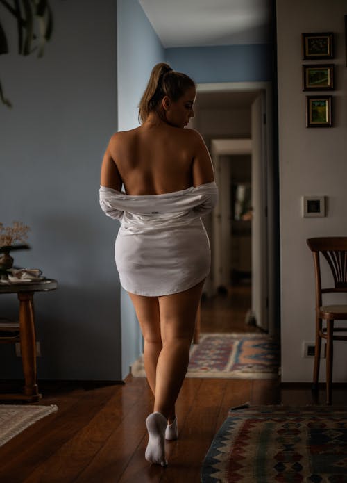 Back View of a Woman Removing her Clothes