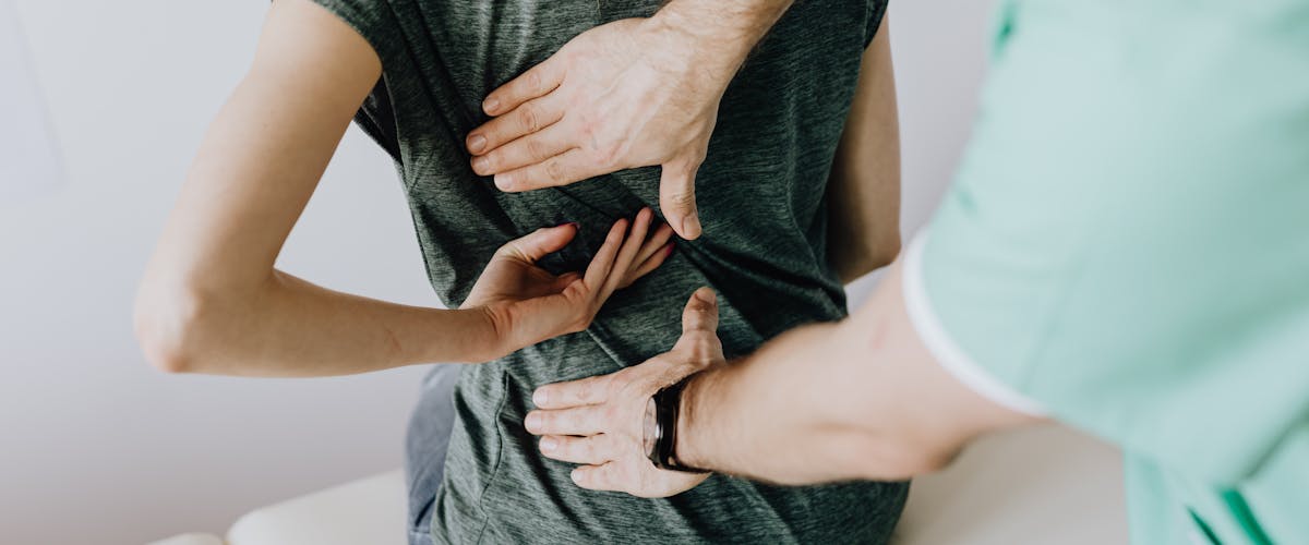 Chiropractor examining patient's spine