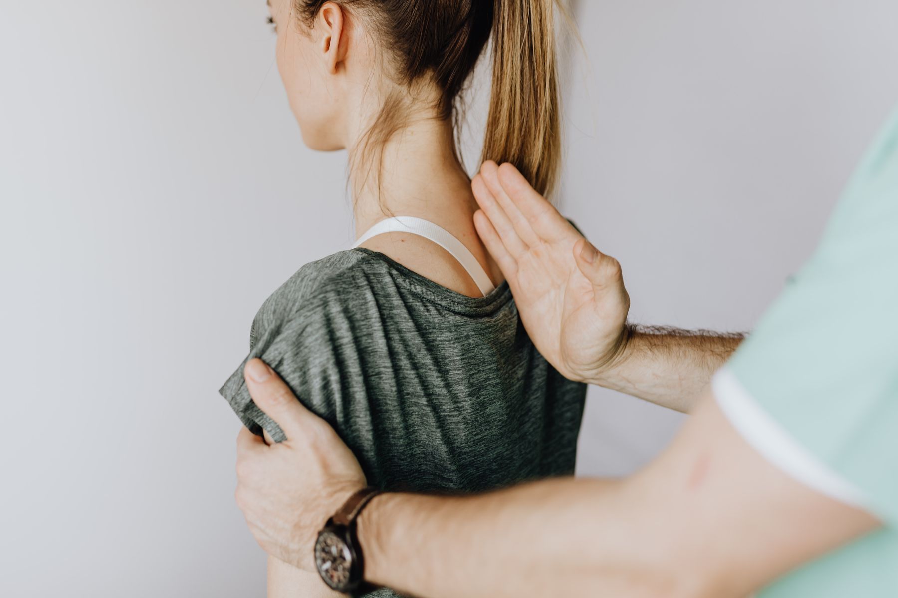 Osteopath performing a careful back assessment