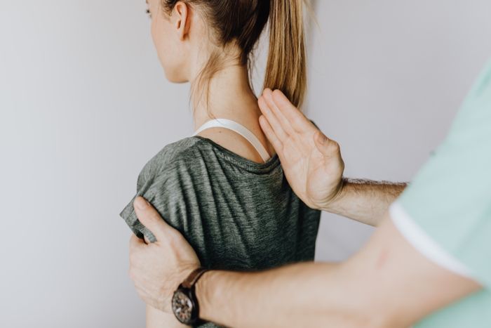 Physiotherapist guiding a patient through a rehabilitation exercise