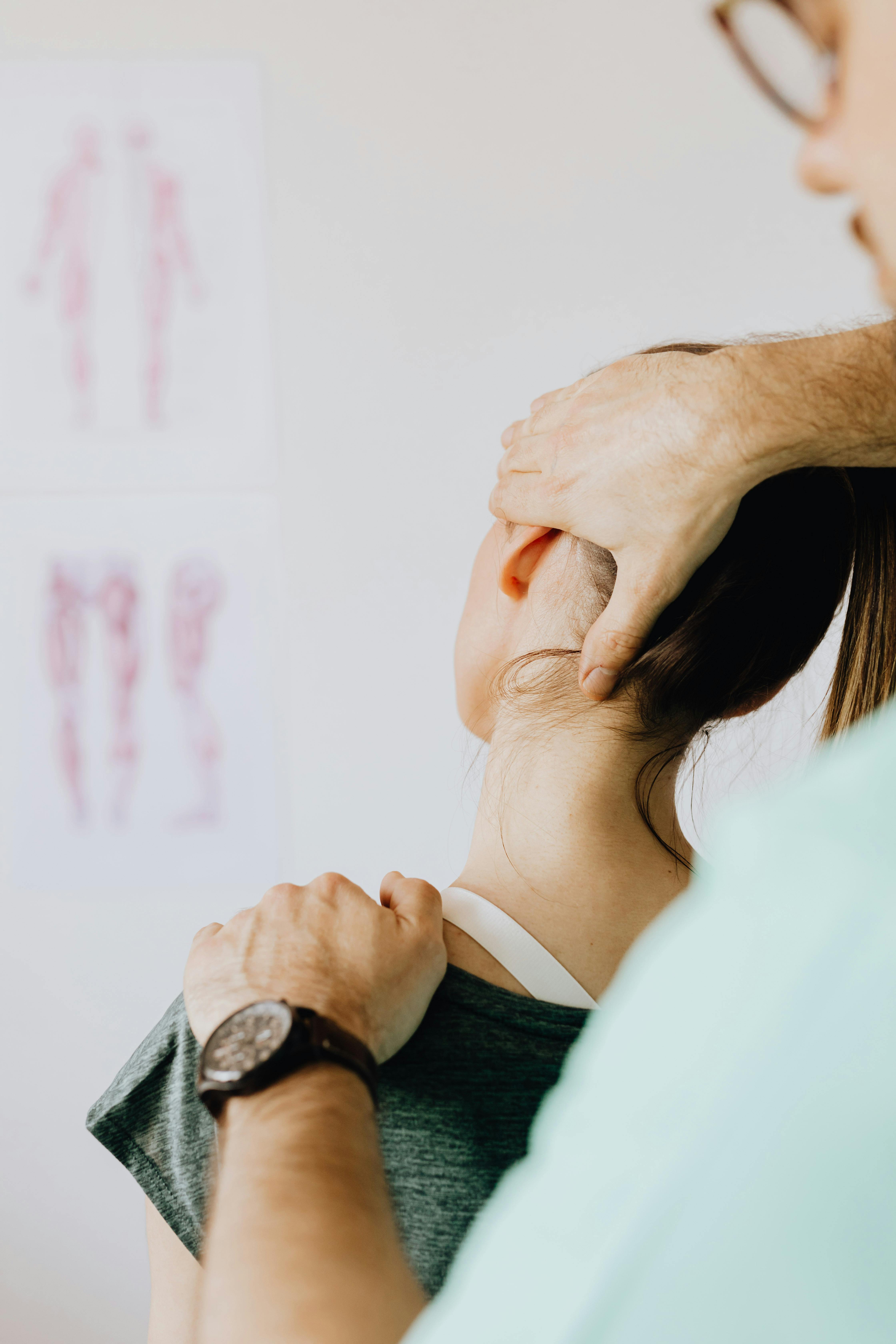 professional massage therapist treating a female patient s injured neck